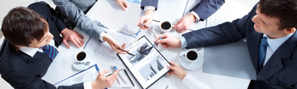 Above view of business team discussing papers at meeting